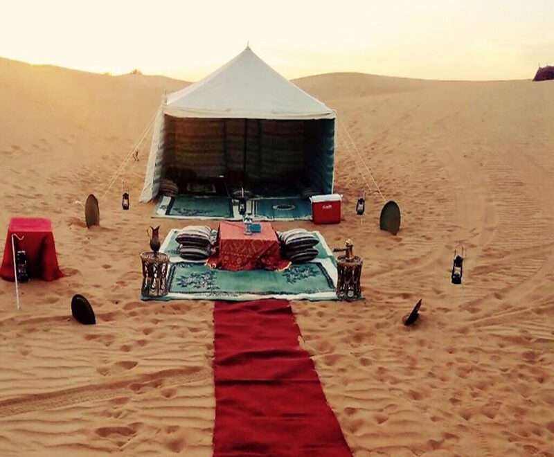 Sunrise over the Arabian Desert with a luxurious 4x4 vehicle on a desert safari adventure. Sunrise Desert Safari